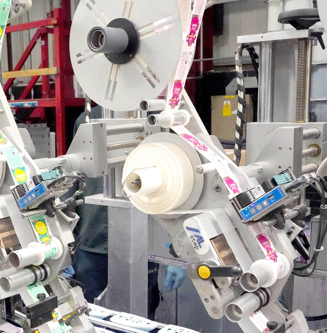 Industrial label printing machine with colorful label rolls feeding through the mechanism.