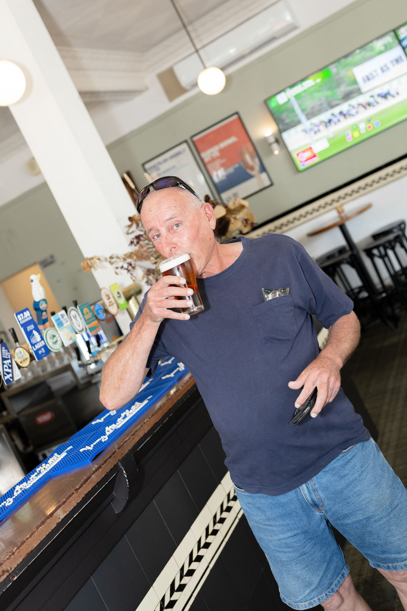Guest enjoying a cold beer at the bar at Young Street Hotel