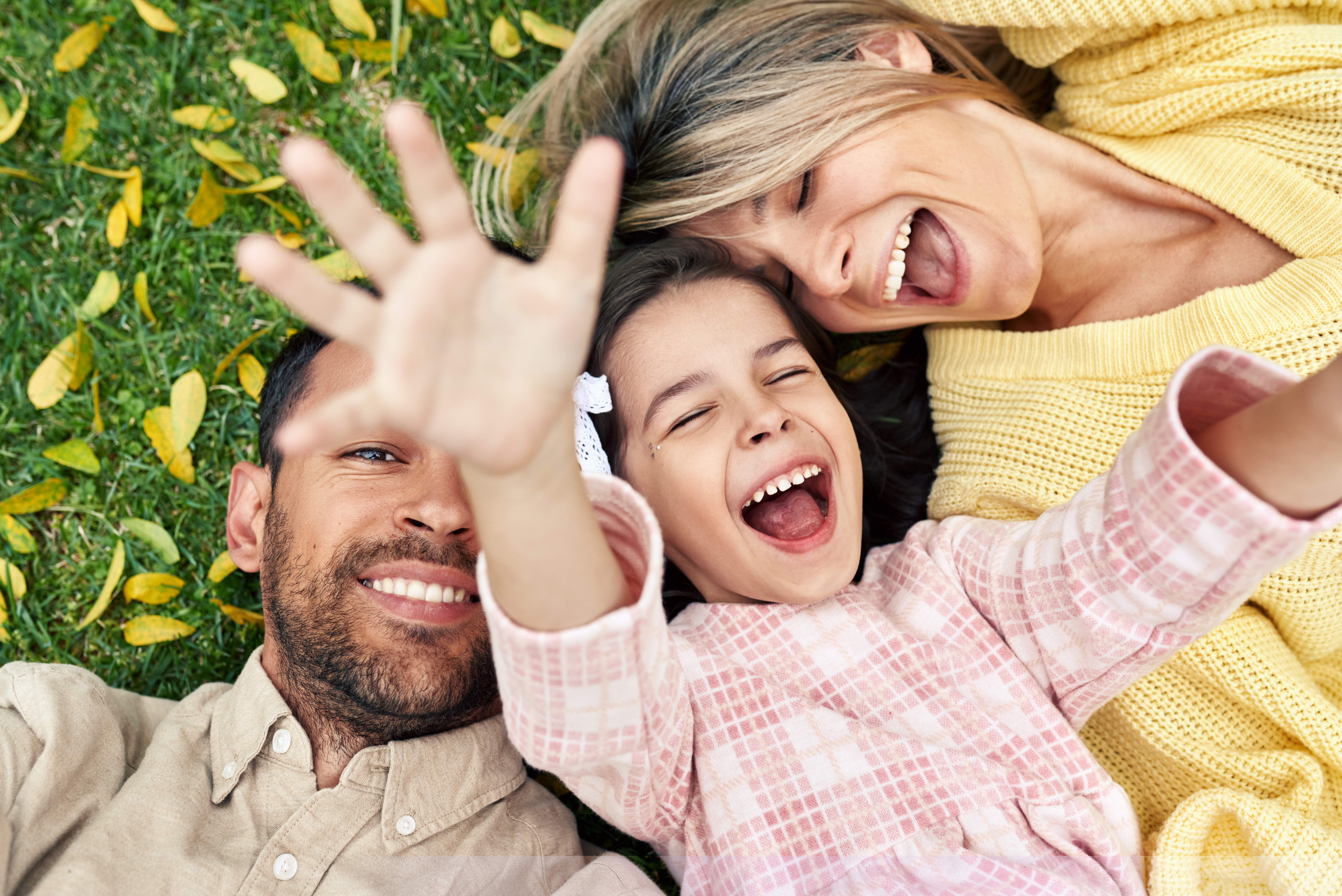 Family laying in grass stock image