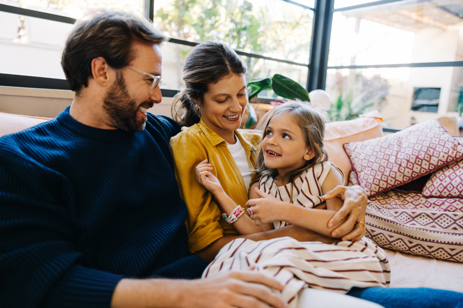 Family smiling on couch 
