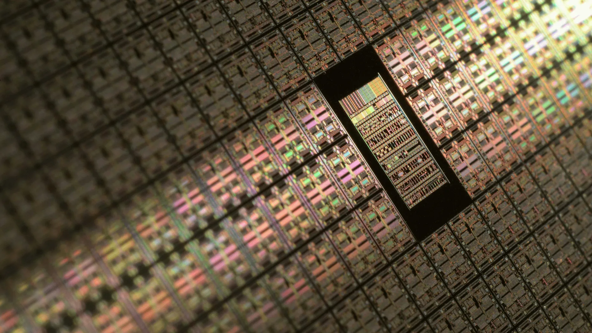 Close-up of a microprocessor chip die showing intricate circuits and connections.