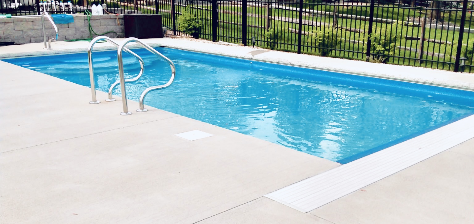 Rectangular inground pool with steps and handrail in Blue Ash, Ohio