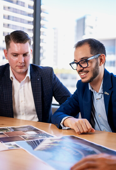 Realm Sales team discussing project plans around a table.