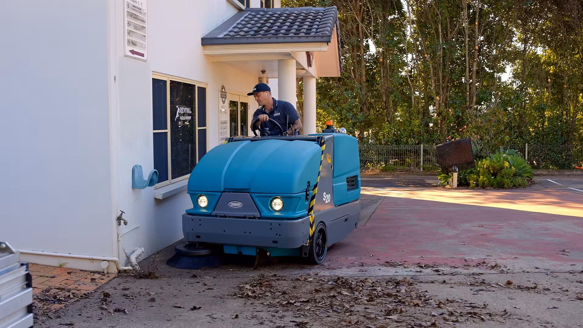 Industrial sweeping machine cleaning warehouse floor