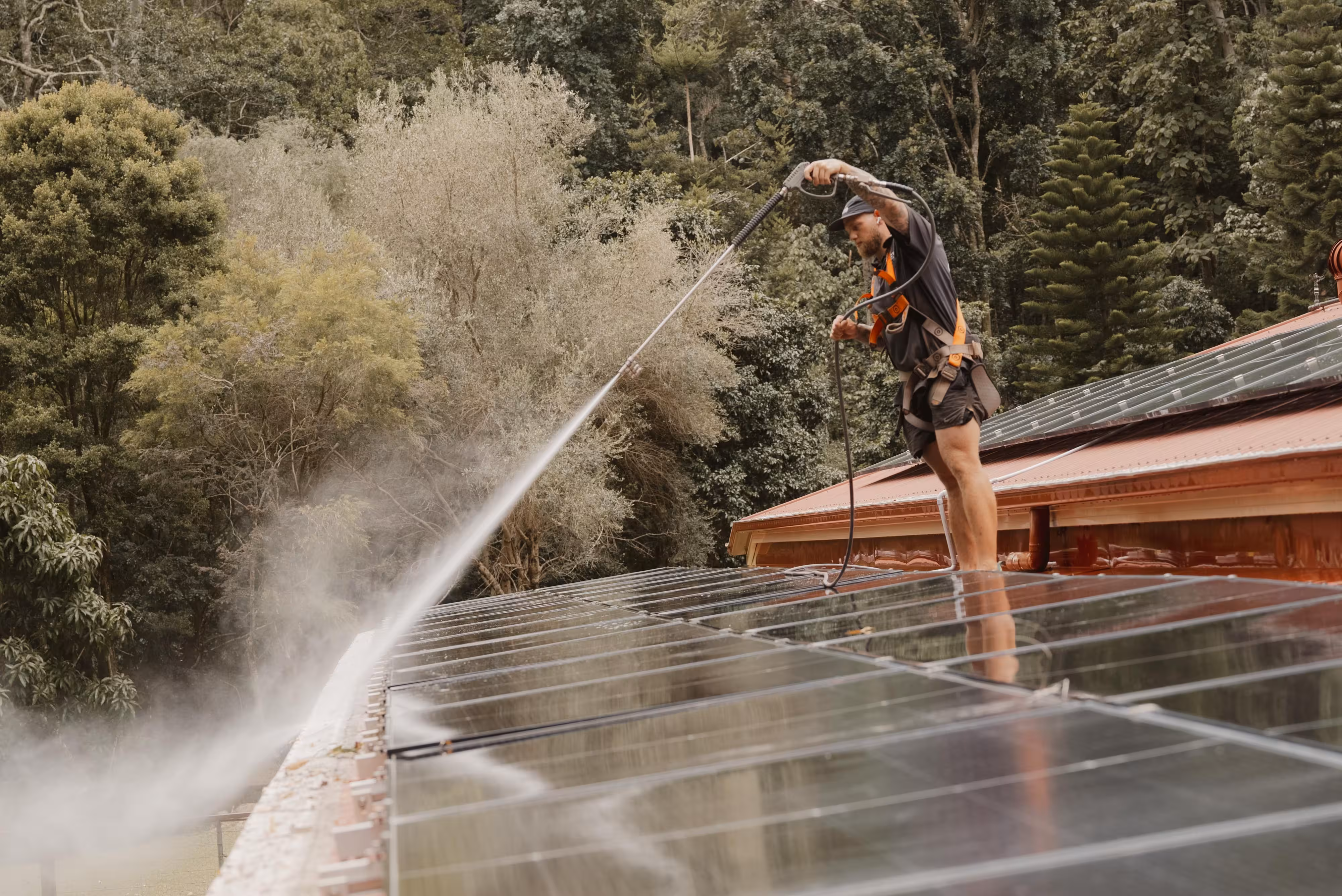 Roof and solar panel cleaning using high-pressure water system