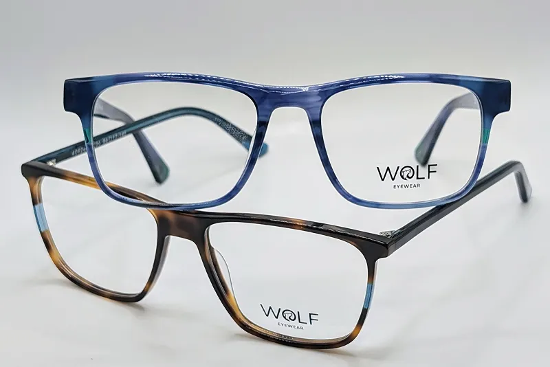 Two pairs of rectangular eyeglasses, one blue and one brown, with Wolf Eyewear logo on lenses.