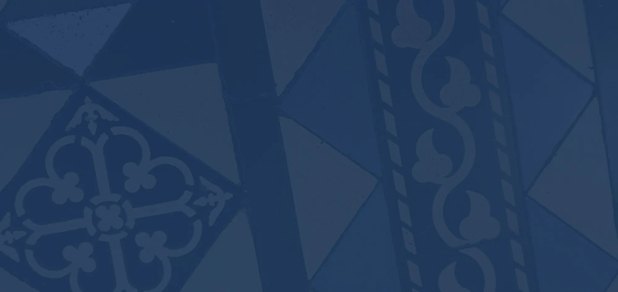 Close-up of blue and gray decorative patterned ceramic tiles arranged in geometric shapes.