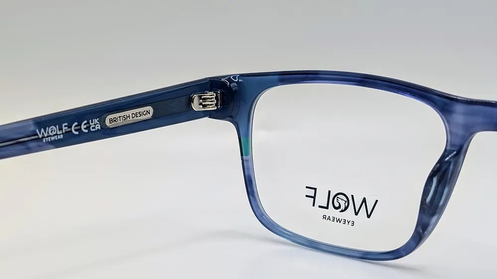 Close-up of blue marbled Wolf Eyewear glasses frames, showing the temple branding and lens detail.