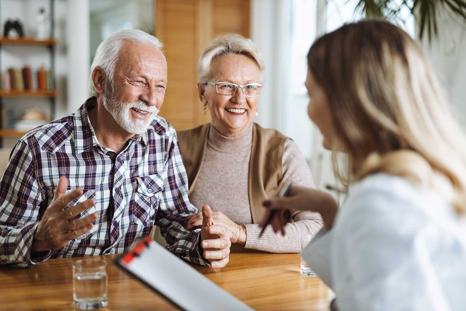 Audiologist discussing hearing test results with a couple during an appointment