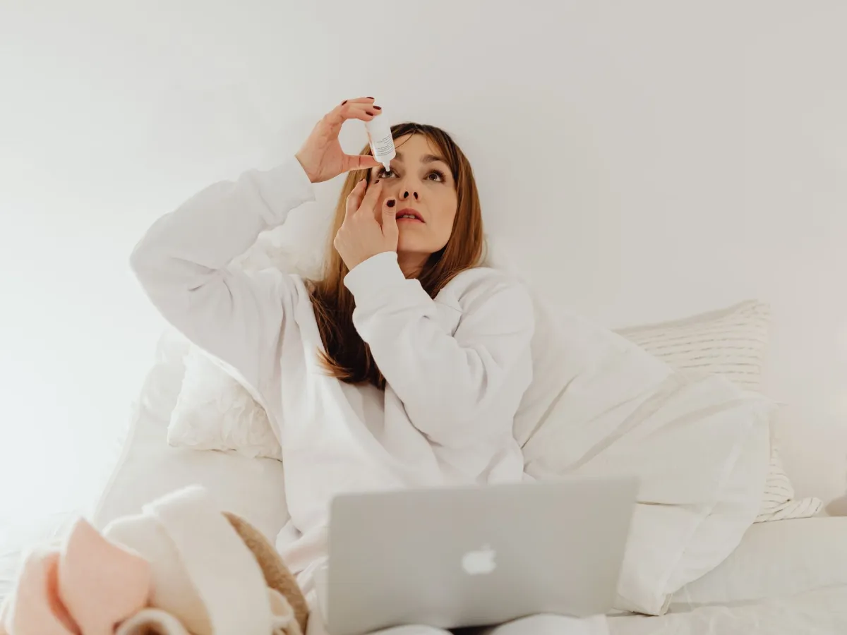 Woman using eye drops to relieve dry eyes after screen time