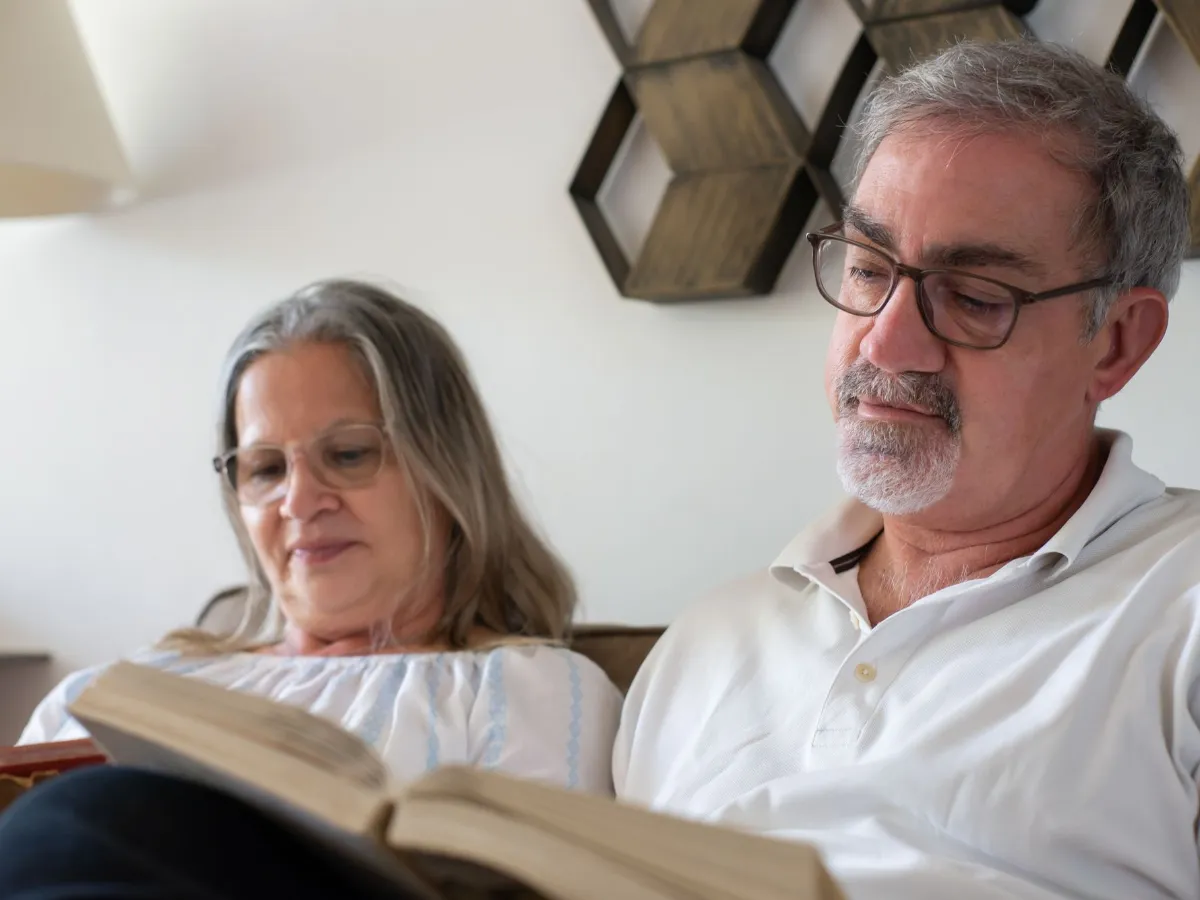 Older couple reading together at home