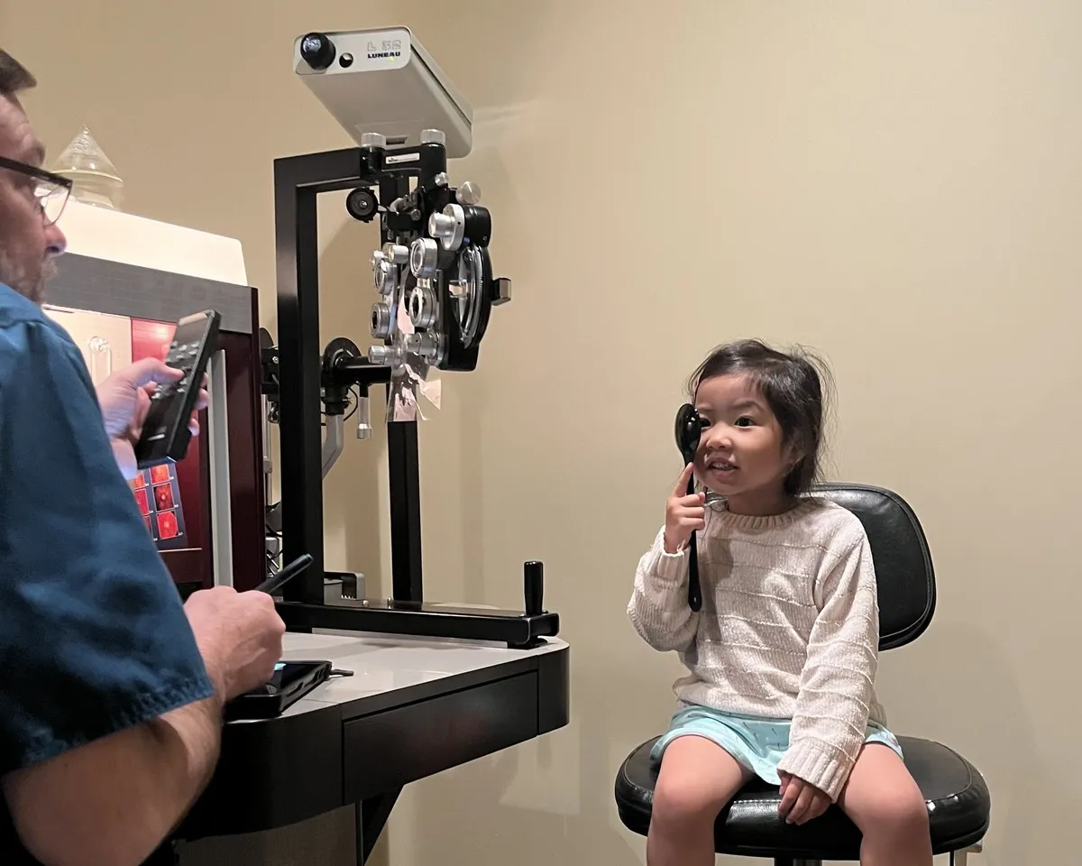 Young patient covering one eye during a vision test at Southside Eyecare & Optical in Anchorage