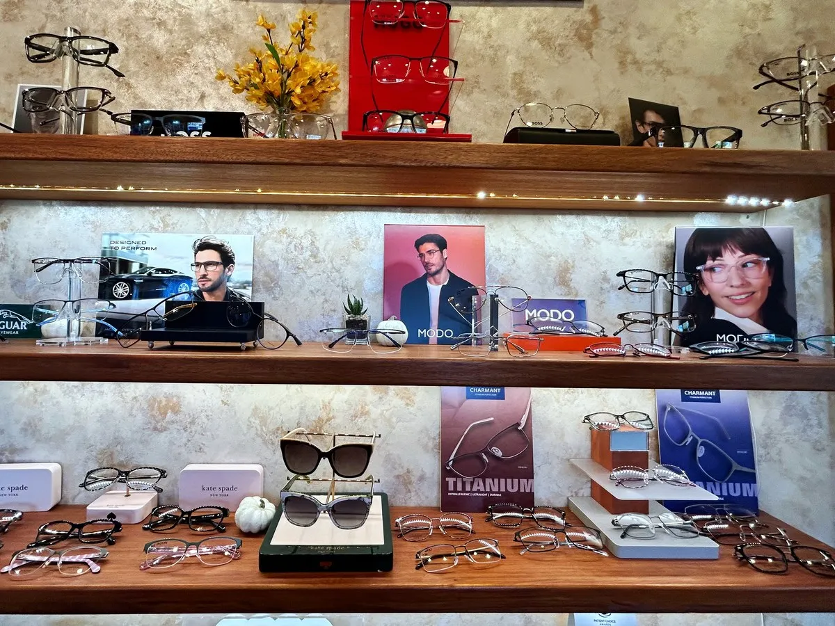 Eyeglass frames on lit wooden shelves in the Southside Eyecare & Optical optical department in Anchorage