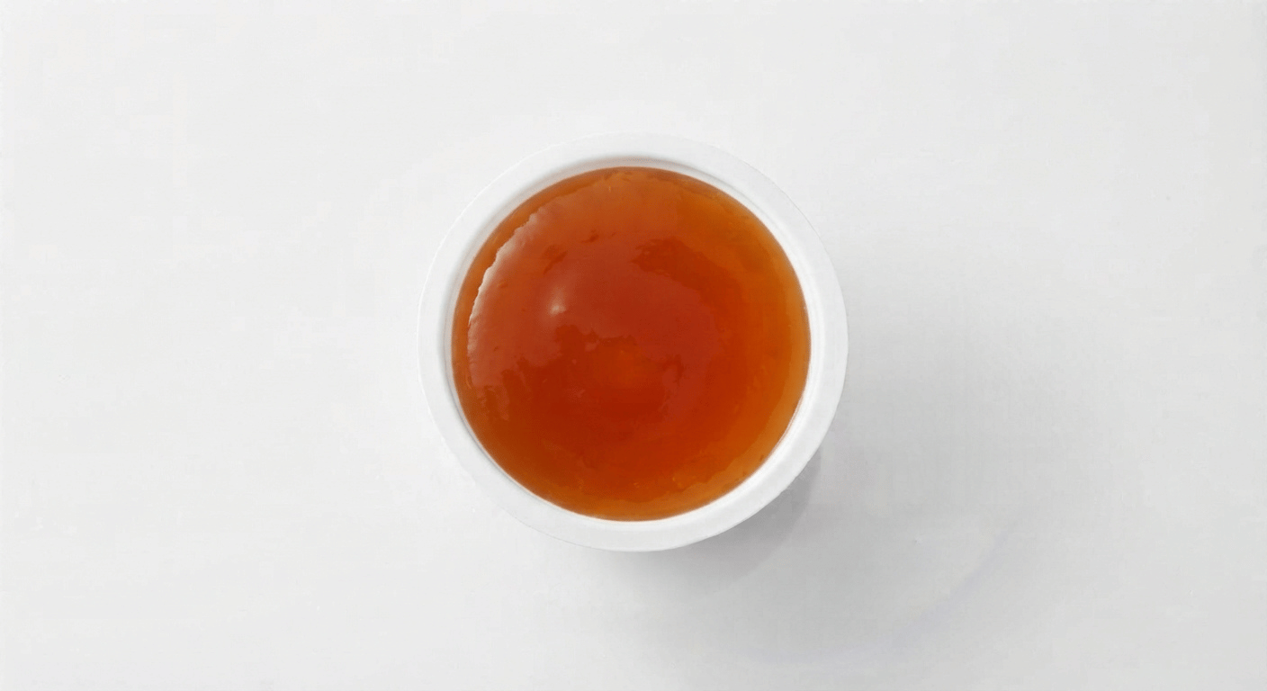 McDonald's Sweet and Sour Dip, a small pot of glossy translucent orange sweet and sour sauce