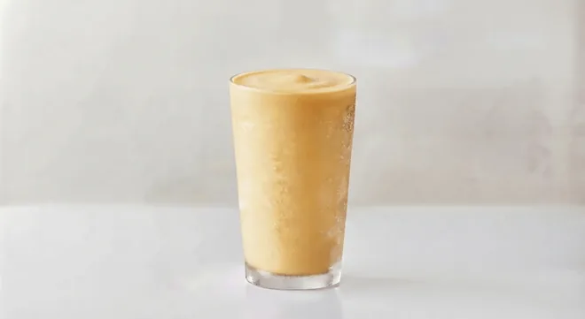 Wingstop Mango Milkshake, mango milkshake in a tall clear glass, nutrition and calories