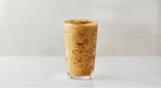 Wingstop Biscoff & Salted Caramel Milkshake, Biscoff and salted caramel milkshake with biscuit crumb in a tall clear glass, nutrition and calories