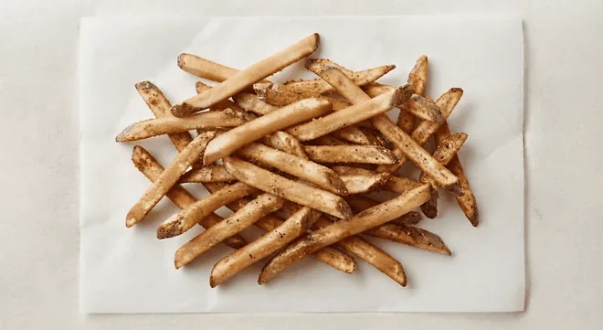Wingstop Plain Fries, plain skin-on fries on white paper, nutrition and calories