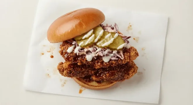 Wingstop Spicy Korean Q Burger, crispy chicken burger in spicy Korean Q sauce with pickles and slaw in a brioche bun, nutrition and calories