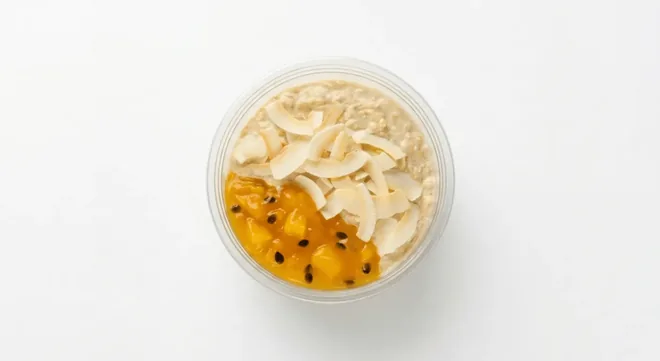 Starbucks Mango & Passionfruit Overnight Oats, pot of overnight oats topped with mango and passionfruit, seen from above, nutrition and calories