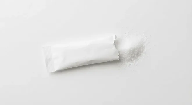 McDonald's Canderel Yellow Sweetener Sachet, paper sugar stick with spilled sugar, nutrition and calories