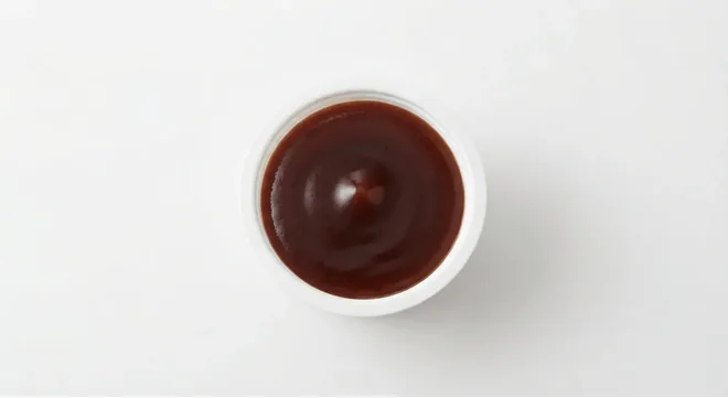 McDonald's Korean BBQ Dip, dark Korean BBQ dip in a small white pot, seen from above, nutrition and calories