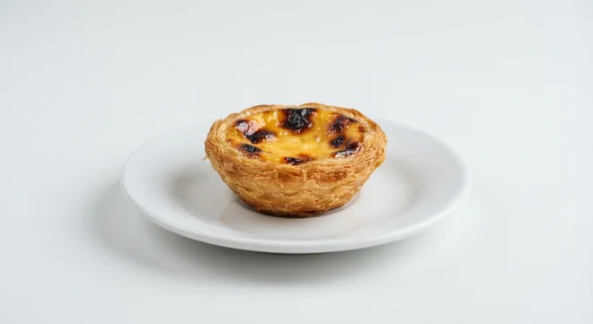 Pret A Manger Pastel De Nata, Portuguese custard tart on a white plate, nutrition and calories