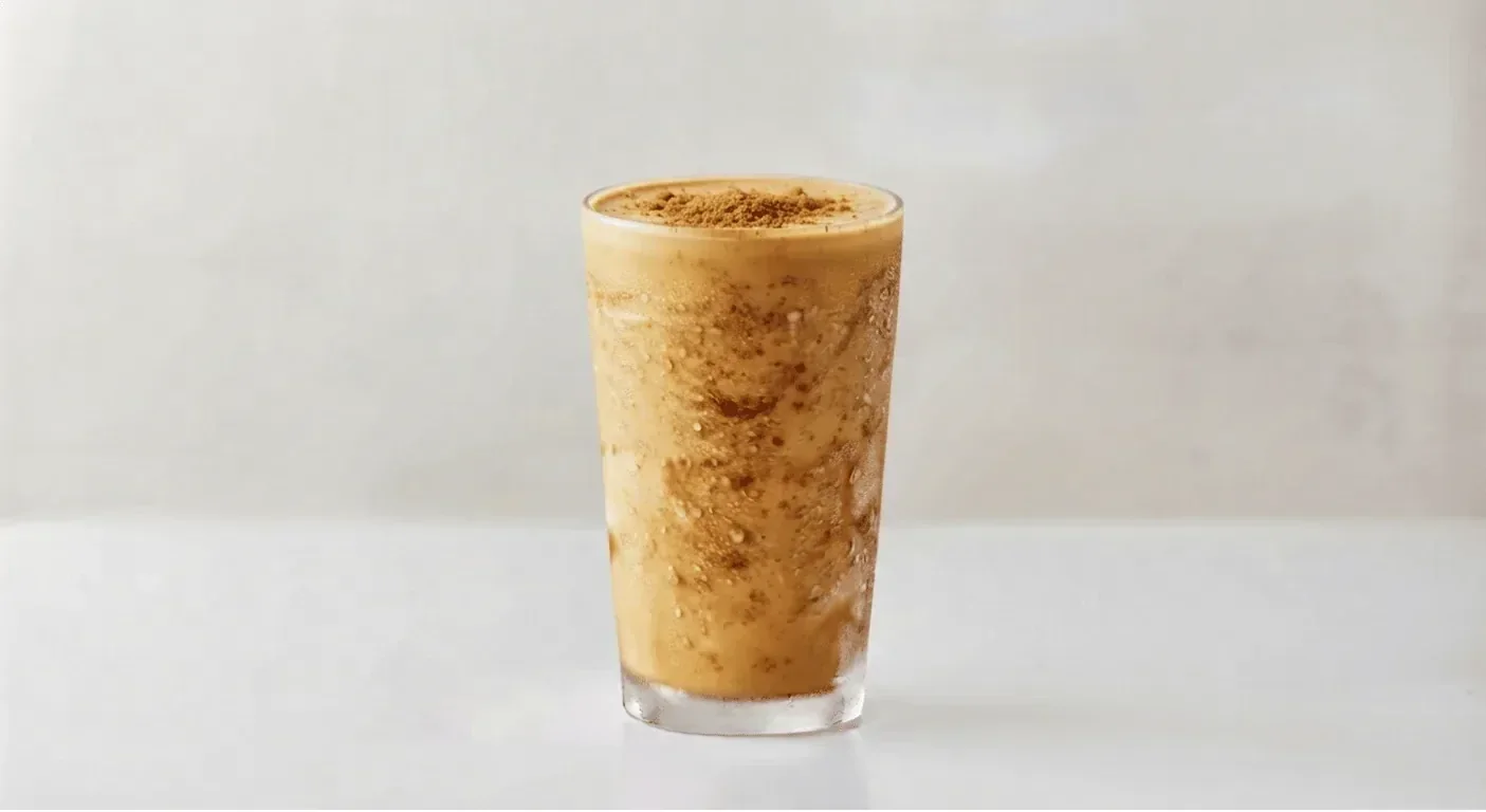 Popeyes Large Biscoff Shake, thick caramel biscuit milkshake with a Biscoff crumb topping in a tall clear glass, nutrition and calories