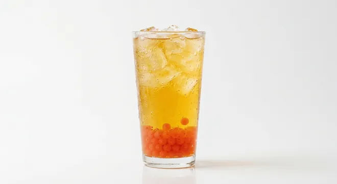 McDonald's US Mango Pineapple Refresher, a golden fruit drink over ice with orange fruit pearls settled at the base