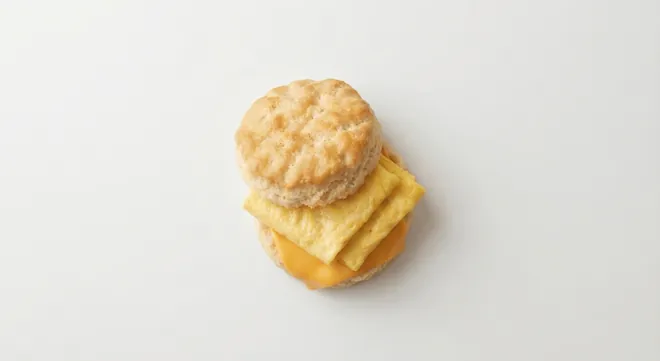 McDonald's US Egg & Cheese Biscuit with a folded egg and melted American cheese in a split buttermilk biscuit