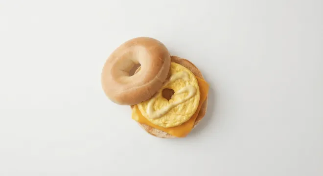 McDonald's US Egg & Cheese Bagel with folded egg, melted American cheese and breakfast sauce on a toasted bagel