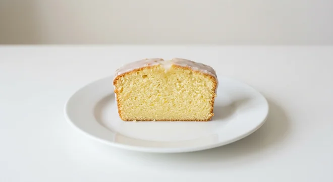 Costa Lemon Drizzle Loaf Cake, slice of lemon drizzle loaf cake with white icing on a white plate, nutrition and calories