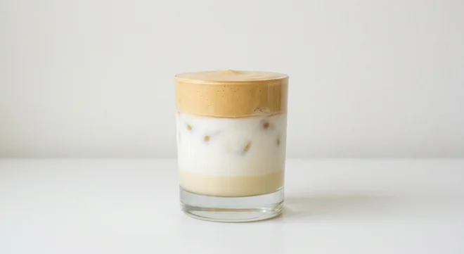 Costa White Chocolate Iced Whipped Latte (Small, Soya Milk), layered iced latte with white chocolate sauce, white milk and a whipped coffee top in a glass tumbler, nutrition and calories