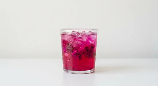 Costa Dragon Fruit & Guava Refresher (Large), pink iced fruit refresher with crushed ice and dragon fruit pieces in a glass tumbler, nutrition and calories