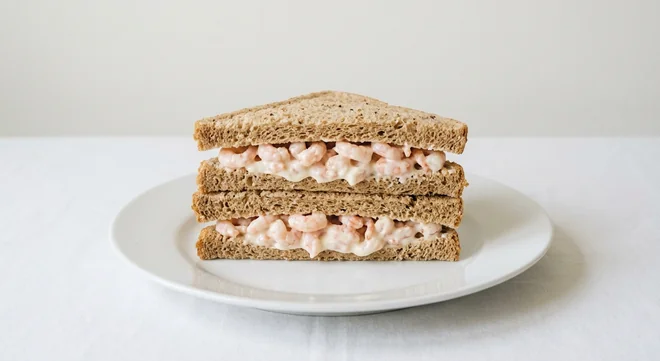 Costa Prawn Mayo Sandwich, prawn mayonnaise sandwich on brown bread cut into triangles on a white plate, nutrition and calories
