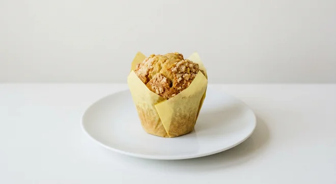 Costa Sicilian Lemon Muffin, lemon muffin with sugar crumble top in a paper case on a white plate, nutrition and calories