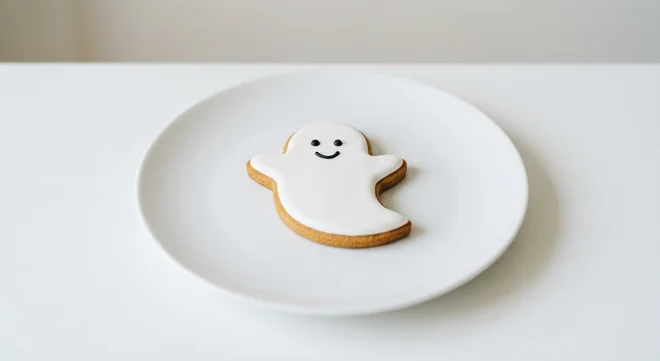 Costa Iced Ghost Gingerbread Biscuit, ghost-shaped gingerbread biscuit with white icing and a smiling face on a white plate, nutrition and calories