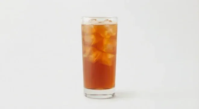 Chick-fil-A Half-Half (Sweet Tea/Lemonade, Regular), amber iced tea and lemonade blend over ice in a tall clear glass, nutrition and calories