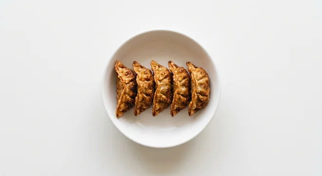 Wagamama Duck Gyoza, five crisp deep-fried duck gyoza dumplings in a white bowl, nutrition and calories