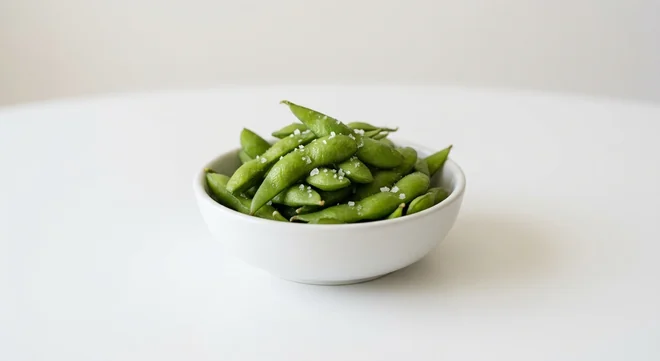 Wagamama Edamame with Salt, steamed green edamame pods with sea salt flakes in a white bowl, nutrition and calories