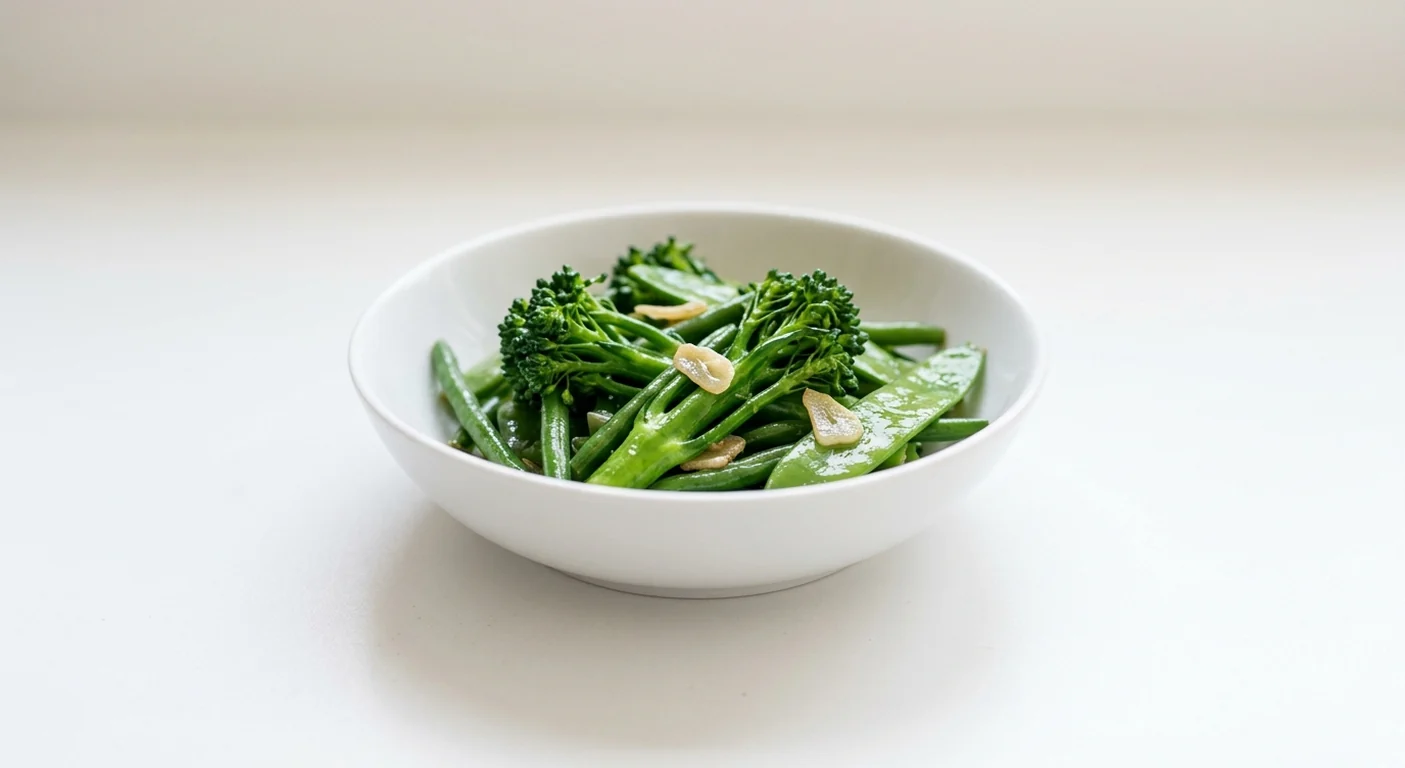 Wagamama Wok-Fried Greens, tenderstem broccoli, fine beans and mangetout in garlic soy sauce in a white bowl, nutrition and calories