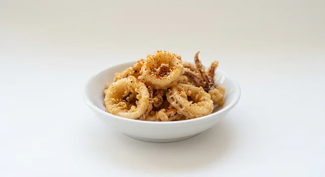 Wagamama Chilli Squid, crispy fried squid dusted with shichimi spice in a white bowl, nutrition and calories