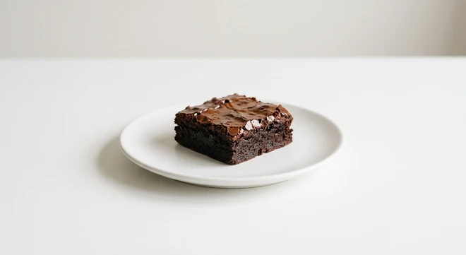 Pizza Express Piccolo Chocolate Brownie, small square of chocolate brownie on a small white plate, nutrition and calories