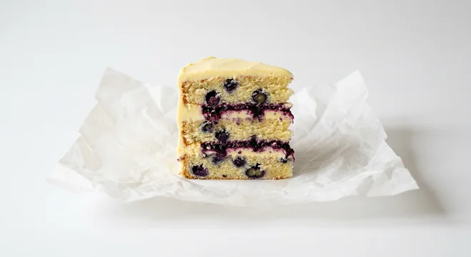 Caffè Nero Lemon and Blueberry Cake, slice of layered lemon sponge with blueberries, lemon frosting and blueberry compote, nutrition and calories