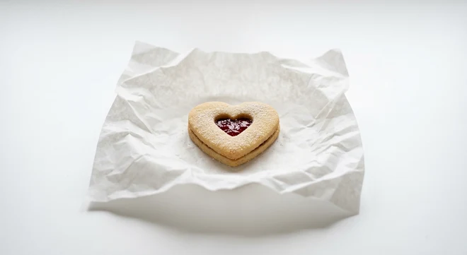 Greggs Jammy Heart Biscuit, heart-shaped jam sandwich biscuit on white paper, nutrition and calories
