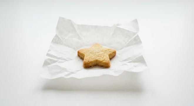 Greggs Star Biscuit, star-shaped sugared shortbread biscuit on white paper, nutrition and calories