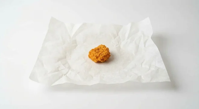Taco Bell Chicken Bite (1), 1 crispy chicken bite on white paper, nutrition and calories