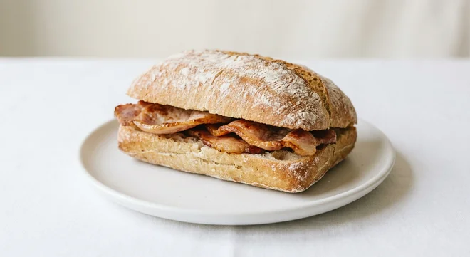 Pret A Manger Triple Bacon Ciabatta, back bacon ciabatta roll on a white plate, nutrition and calories