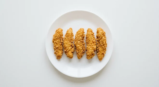 Pizza Hut Breaded Chicken Tenders, 5 golden breaded chicken strips, on a white plate, nutrition and calories