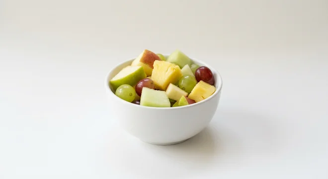 Pret A Manger Fruit Salad, apple, pineapple, melon and grape fruit salad in a small bowl, nutrition and calories