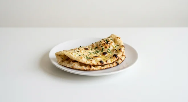 Wetherspoon Garlic Naan, folded garlic naan bread on a white plate, nutrition and calories